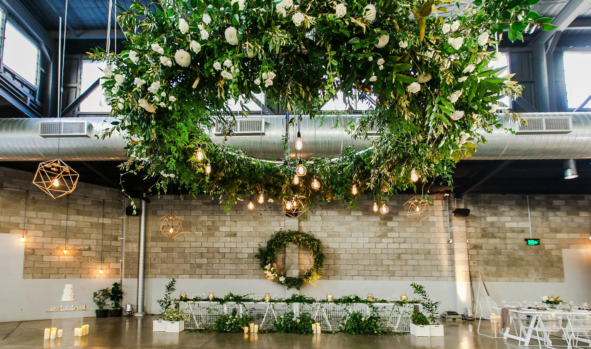 Low hanging floral installation above wedding reception tables.